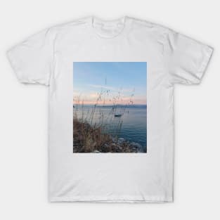 Serene Ocean Sunset: Boat Amidst Weeds T-Shirt